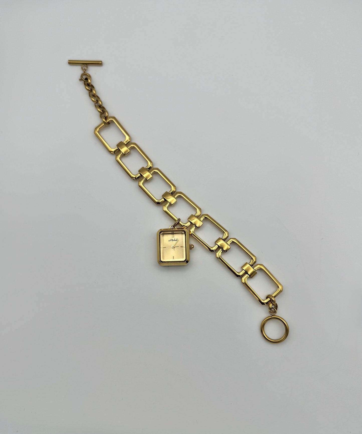 A gold-colored watch with a square face and a bracelet strap - Bold design - unique design