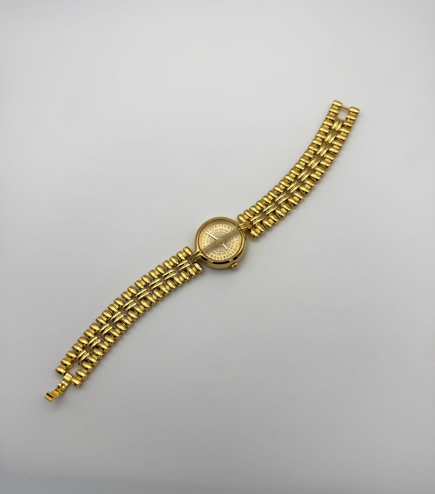 A gold-colored analog watch with a link bracelet and a round dial - Vintage newyork style